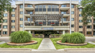 Exterior of Apple Valley Villa senior living building with balconies and main entrance.