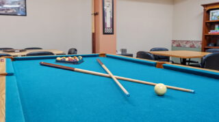 Billiards table and seating area at Apple Valley Village.