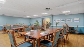 Cafe dining area with tables and seating at Apple Valley Village.