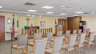 Chapel seating area with chairs and worship space at Apple Valley Village.