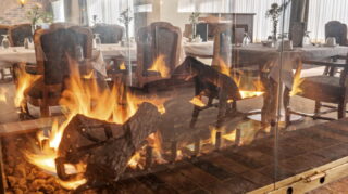 Dining room with fireplace and seating area at Apple Valley Village.