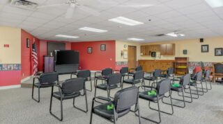 Fitness center with exercise machines and open workout space at Apple Valley Village.