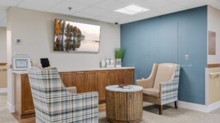 Health care center seating area with chairs and table at Apple Valley Village.