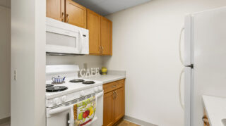 Kitchen appliances and cabinets in apartment at Apple Valley Village.