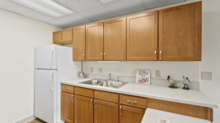 Kitchen with cabinets and appliances at Apple Valley Village.