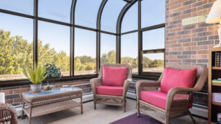 Memory care lounge with chairs and natural light at Apple Valley Village.