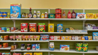 Snack and grocery items on shelves in convenience store at Apple Valley Village.
