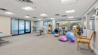 Therapy room with rehabilitation equipment at Apple Valley Village.