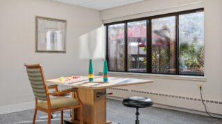 Therapy workstation with table and seating at Apple Valley Village.