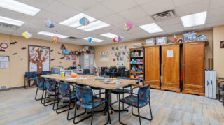 Group activity room with tables and seating at Open Circle adult day program.