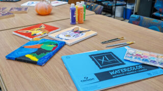 Activity table with art supplies and materials at Open Circle adult day program.