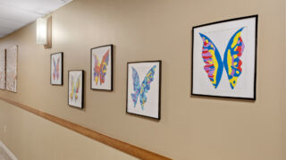 Hallway with framed artwork in Open Circle adult day program at Apple Valley.