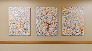 Art projects displayed on wall at Open Circle adult day program in Apple Valley.